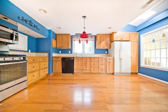 38 Kimball Beach Rd, Hingham, MA 02043 - kitchen with stainless steel appliances, light countertops, light wood finished floors, and a sink