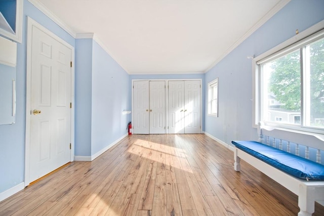 38 Kimball Beach Rd, Hingham, MA 02043 - unfurnished bedroom with multiple closets, light wood finished floors, baseboards, and crown molding