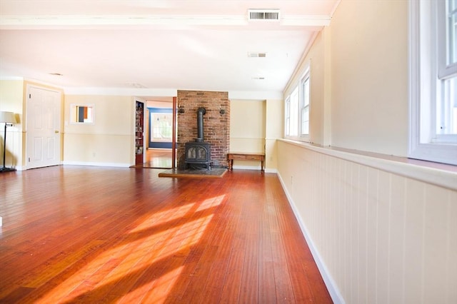38 Kimball Beach Rd, Hingham, MA 02043 - unfurnished living room with a wood stove, wood finished floors, and baseboards