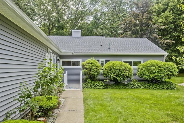 83 Horseshoe Dr Unit 83, Chicopee, MA 01022 - property entrance featuring a lawn, a chimney, and roof with shingles