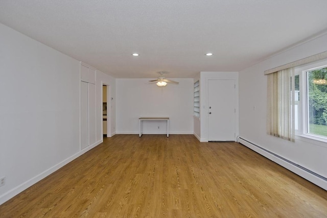 83 Horseshoe Dr Unit 83, Chicopee, MA 01022 - unfurnished living room featuring a baseboard heating unit, light wood-type flooring, recessed lighting, and a ceiling fan