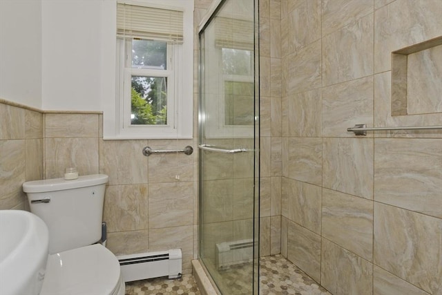 83 Horseshoe Dr Unit 83, Chicopee, MA 01022 - full bathroom with a baseboard heating unit, a stall shower, tile walls, a baseboard radiator, and wainscoting