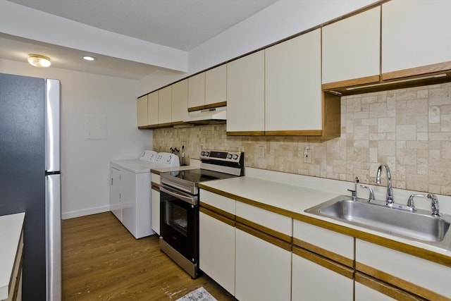 83 Horseshoe Dr Unit 83, Chicopee, MA 01022 - kitchen with appliances with stainless steel finishes, washing machine and clothes dryer, wood finished floors, under cabinet range hood, and light countertops
