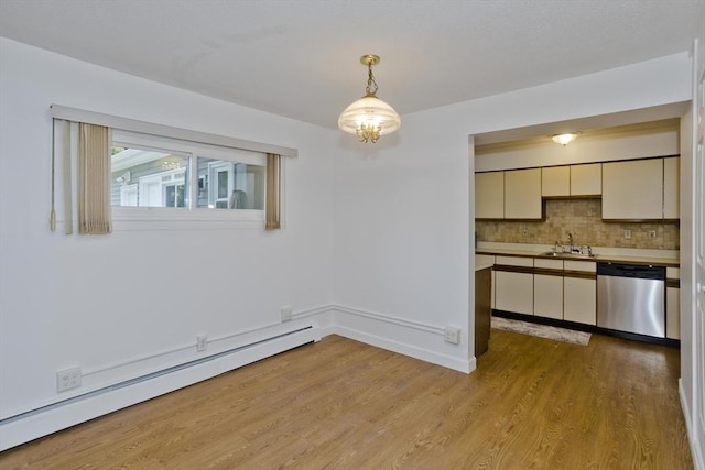 83 Horseshoe Dr Unit 83, Chicopee, MA 01022 - unfurnished dining area featuring a baseboard heating unit, light wood-style flooring, and a chandelier