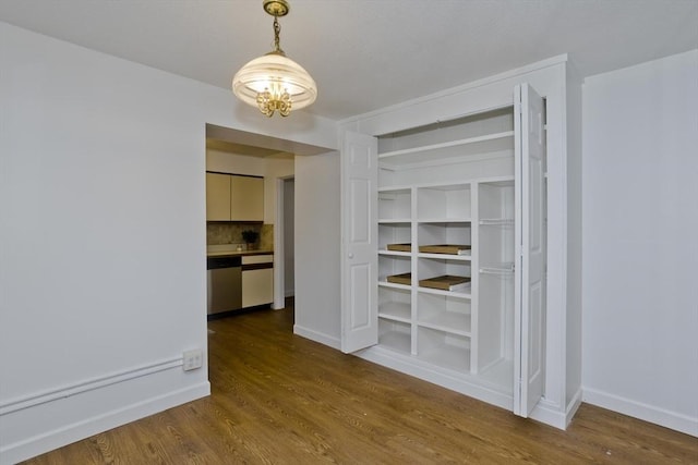 83 Horseshoe Dr Unit 83, Chicopee, MA 01022 - unfurnished dining area featuring wood finished floors and a chandelier