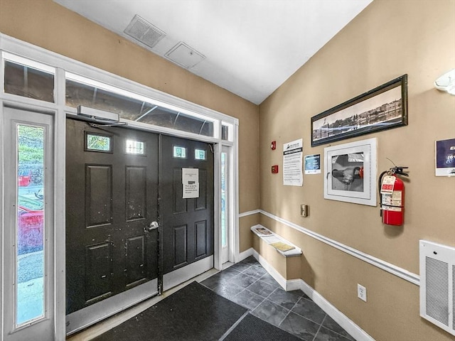 72 River St Unit 2, Haverhill, MA 01832 - foyer featuring dark tile patterned floors and baseboards