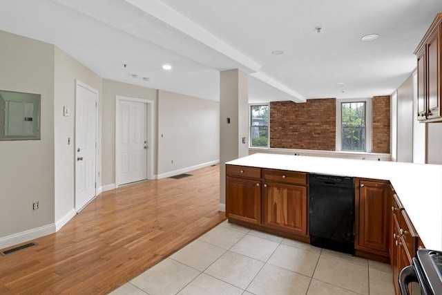 72 River St Unit 2, Haverhill, MA 01832 - kitchen with black dishwasher, electric panel, light countertops, a peninsula, and light wood-style floors