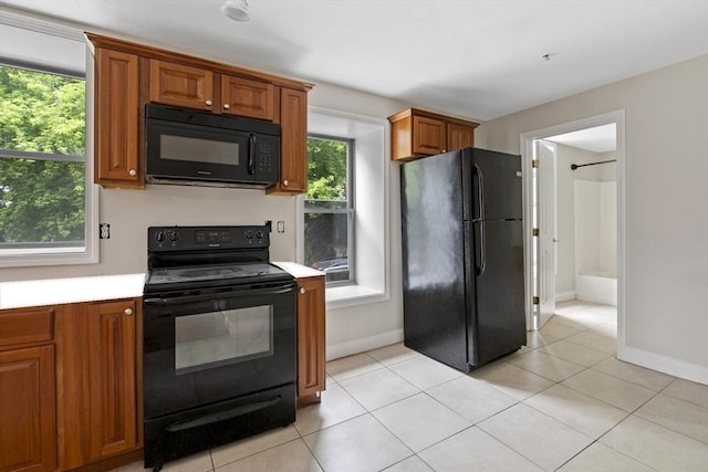 72 River St Unit 2, Haverhill, MA 01832 - kitchen featuring black appliances, brown cabinetry, light countertops, and baseboards
