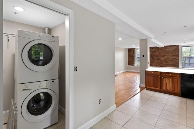 72 River St Unit 2, Haverhill, MA 01832 - laundry area with stacked washer and clothes dryer, baseboards, light tile patterned floors, and recessed lighting