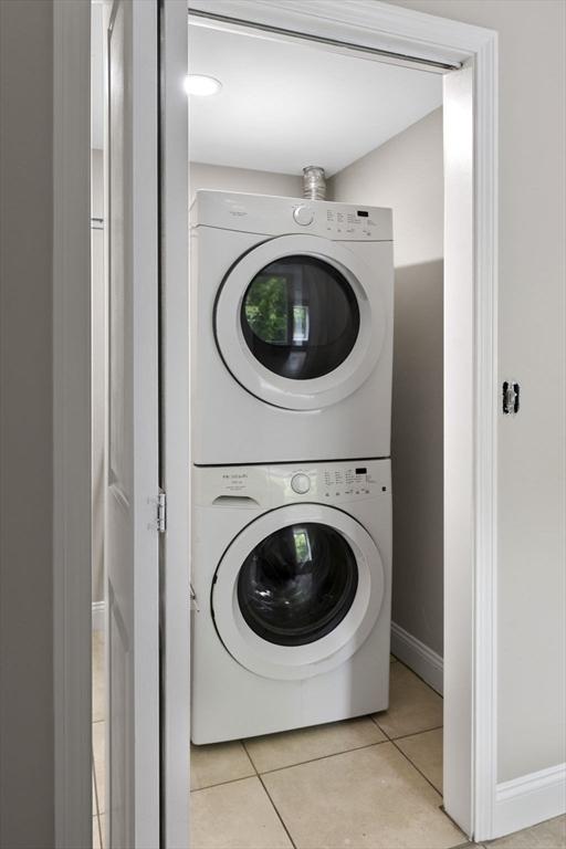 72 River St Unit 2, Haverhill, MA 01832 - washroom with stacked washer / drying machine, tile patterned flooring, and baseboards