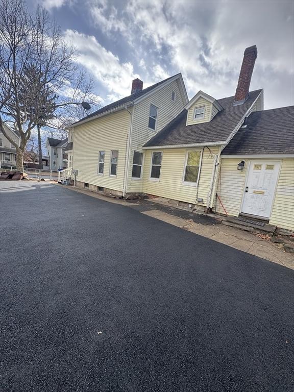 exterior space featuring crawl space and a chimney