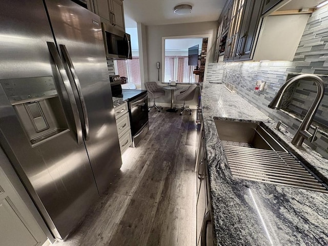 20 Meadowbrook Ln Unit 20, Palmer, MA 01069 - kitchen with stainless steel appliances, dark wood-style flooring, tasteful backsplash, and dark stone counters