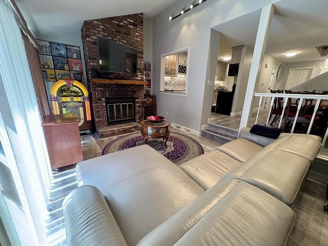 20 Meadowbrook Ln Unit 20, Palmer, MA 01069 - living area featuring a brick fireplace, lofted ceiling, and wood finished floors