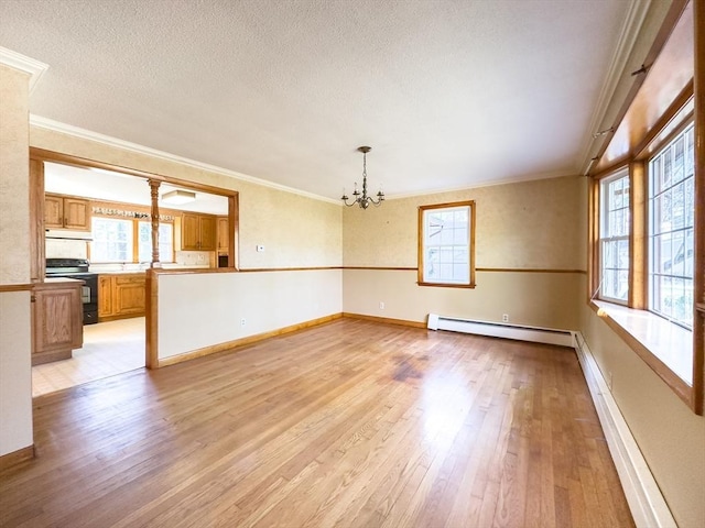 unfurnished room featuring a chandelier, plenty of natural light, a baseboard radiator, and light wood-type flooring