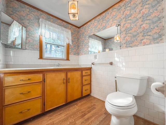 bathroom featuring vanity, ornamental molding, tile walls, and hardwood / wood-style flooring