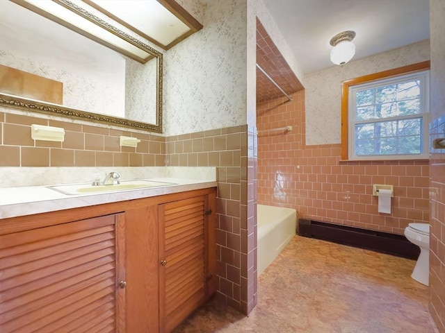 bathroom featuring vanity, toilet, and tile walls