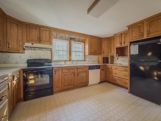 kitchen with backsplash, sink, and black appliances