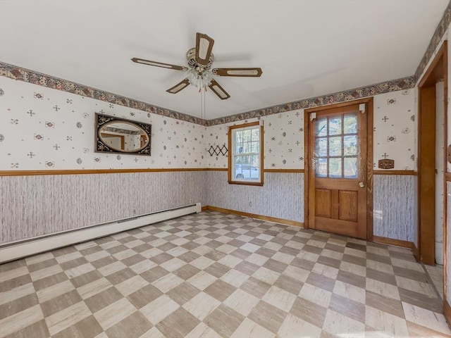 unfurnished room featuring ceiling fan and baseboard heating