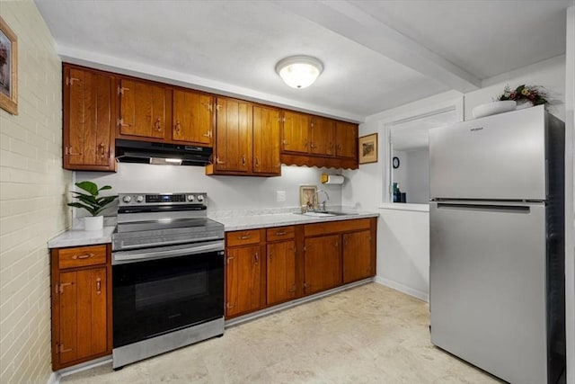 267 Neck St Unit 5A, Weymouth, MA 02191 - kitchen with stainless steel appliances, under cabinet range hood, light countertops, and brown cabinets