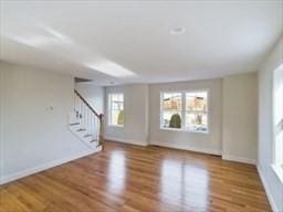 unfurnished living room featuring hardwood / wood-style flooring