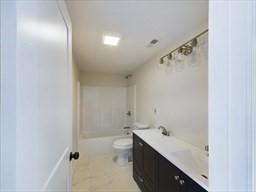 full bathroom featuring vanity, toilet, and shower / bath combination