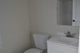 bathroom featuring toilet and vanity