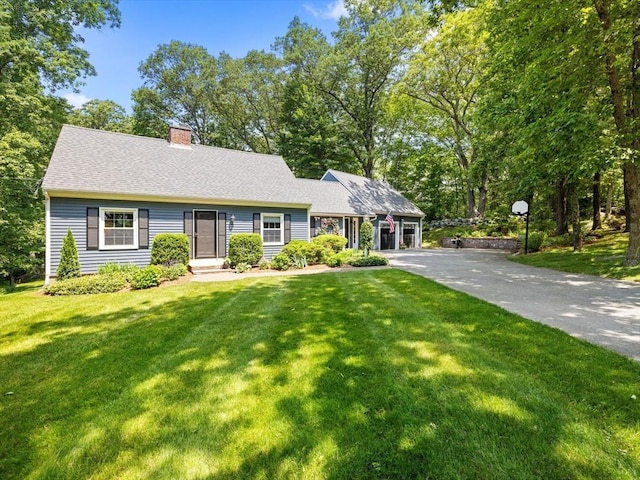 71 Nourse St, Westborough, MA 01581 - view of front of house with a chimney, asphalt driveway, a front lawn, and roof with shingles