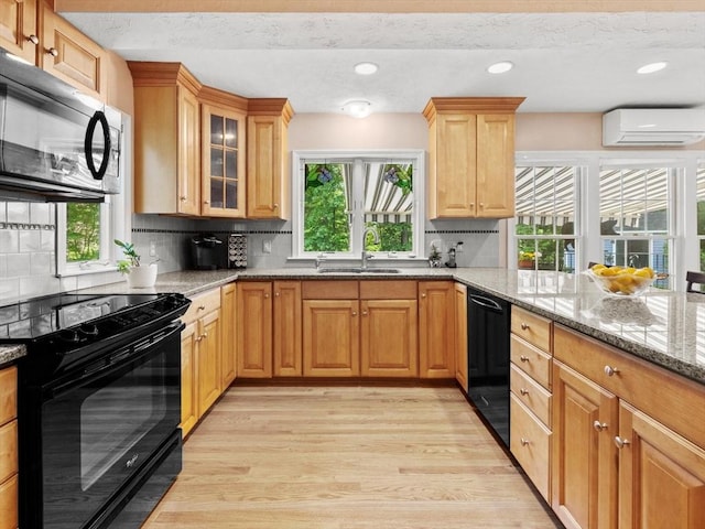 71 Nourse St, Westborough, MA 01581 - kitchen featuring black appliances, a wall mounted air conditioner, plenty of natural light, light wood finished floors, and recessed lighting