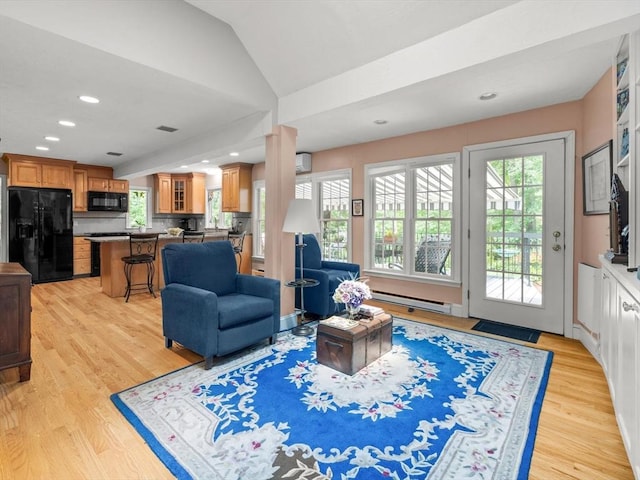 71 Nourse St, Westborough, MA 01581 - living area with healthy amount of natural light, light wood finished floors, baseboard heating, recessed lighting, and vaulted ceiling