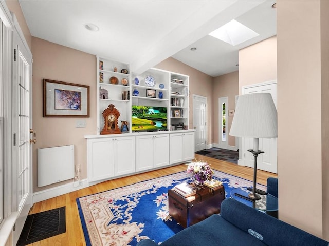71 Nourse St, Westborough, MA 01581 - living area featuring a skylight, light wood-type flooring, and beam ceiling