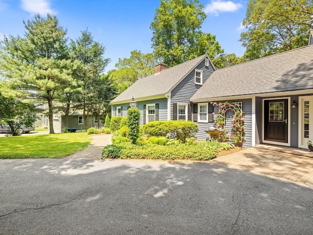 71 Nourse St, Westborough, MA 01581 - view of front facade featuring a chimney, a shingled roof, and a front yard