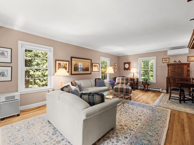 71 Nourse St, Westborough, MA 01581 - living area featuring a baseboard heating unit, a wall mounted air conditioner, light wood finished floors, and ornamental molding