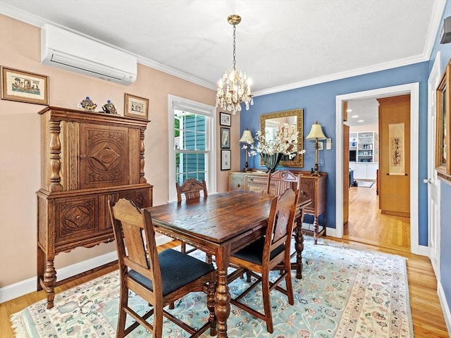 71 Nourse St, Westborough, MA 01581 - dining space featuring a wall unit AC, a chandelier, light wood-style floors, and ornamental molding