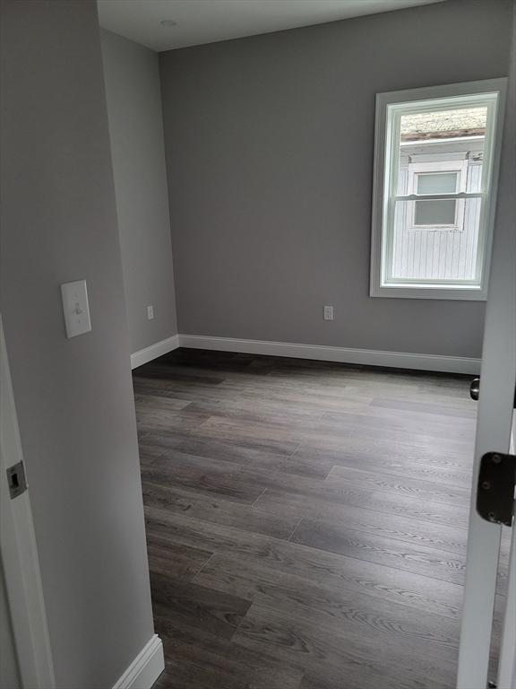314-316 Dartmouth St, New Bedford, MA 02740 - unfurnished room featuring dark wood finished floors and baseboards