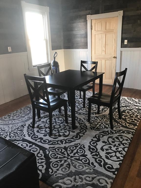 314-316 Dartmouth St, New Bedford, MA 02740 - dining space with wainscoting and dark wood-style flooring