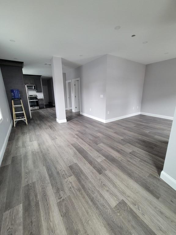 314-316 Dartmouth St, New Bedford, MA 02740 - unfurnished living room with dark wood-type flooring and baseboards