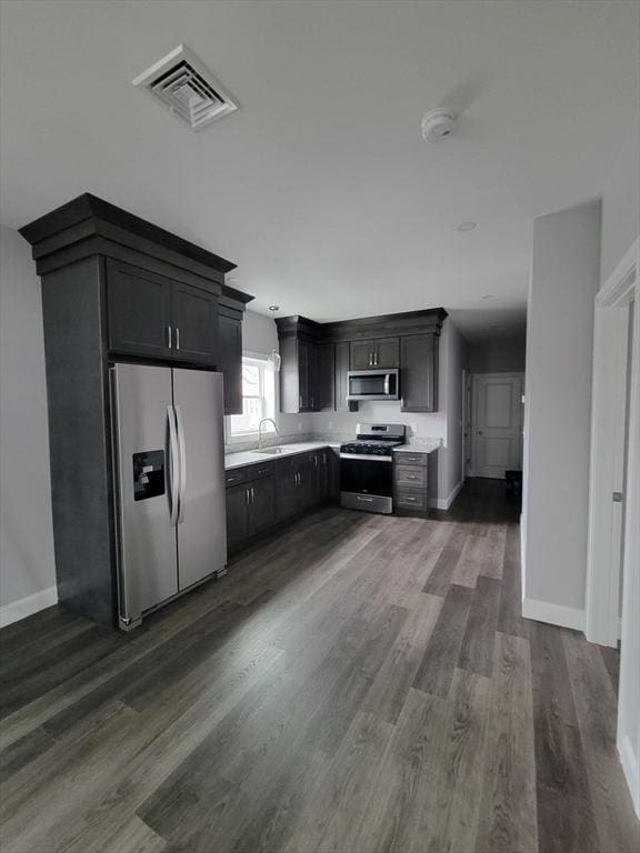 314-316 Dartmouth St, New Bedford, MA 02740 - kitchen with stainless steel appliances, dark wood-style flooring, a sink, light countertops, and baseboards