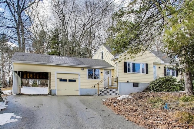 view of front facade with an attached garage and aphalt driveway