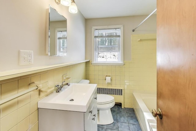 full bath featuring tile patterned flooring, toilet, vanity, tile walls, and radiator