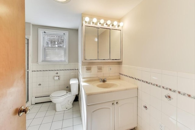 full bathroom featuring tile patterned flooring, toilet, a baseboard heating unit, vanity, and tile walls