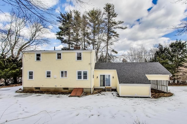 snow covered property featuring entry steps and a chimney