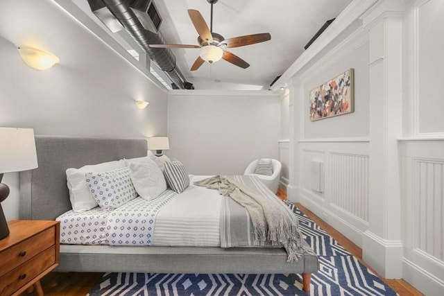 515 Franklin St Unit 4, Cambridge, MA 02139 - bedroom with wood finished floors, a ceiling fan, and a decorative wall