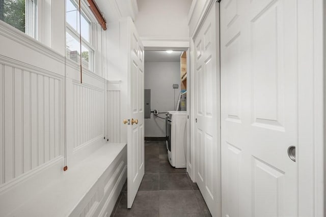 515 Franklin St Unit 4, Cambridge, MA 02139 - hall with washer / clothes dryer, electric panel, dark tile patterned flooring, and a decorative wall