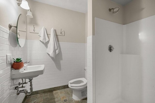 515 Franklin St Unit 4, Cambridge, MA 02139 - bathroom with a shower stall, tile walls, toilet, and a wainscoted wall