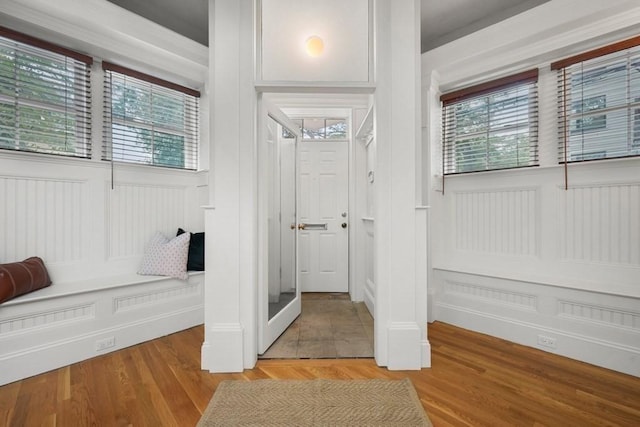 515 Franklin St Unit 4, Cambridge, MA 02139 - bathroom featuring healthy amount of natural light, a decorative wall, and wood finished floors