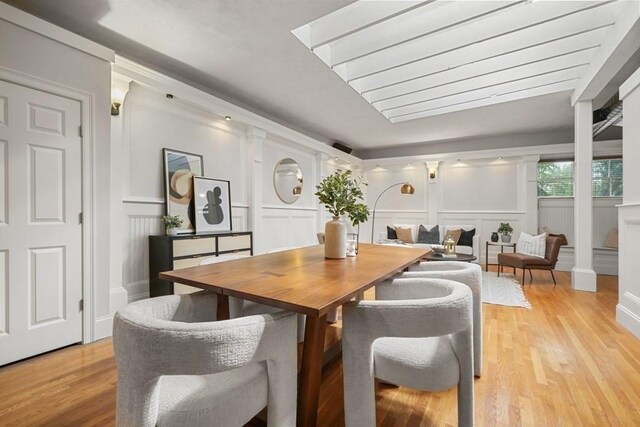 515 Franklin St Unit 4, Cambridge, MA 02139 - dining room with a decorative wall, light wood-style floors, and a wainscoted wall