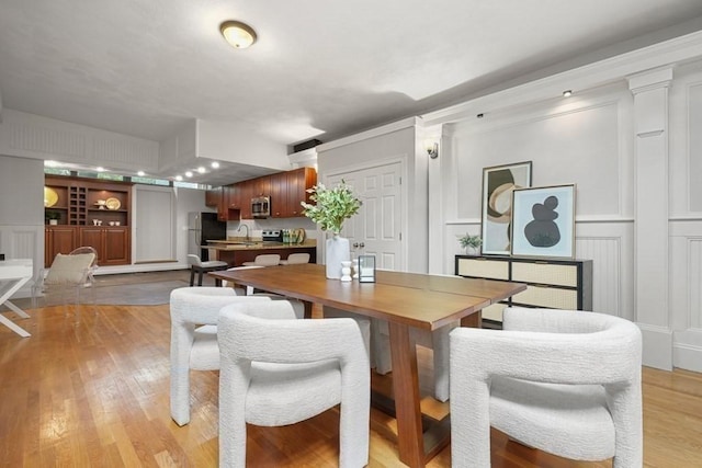 515 Franklin St Unit 4, Cambridge, MA 02139 - dining room with a decorative wall and light wood-style floors