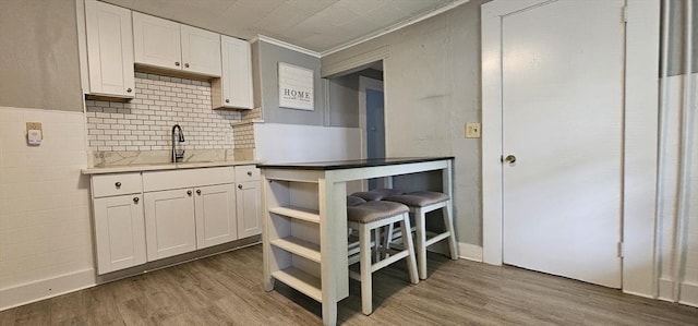 39 Franklin St, Marlborough, MA 01752 - kitchen with a sink, open shelves, white cabinetry, wood finished floors, and light countertops