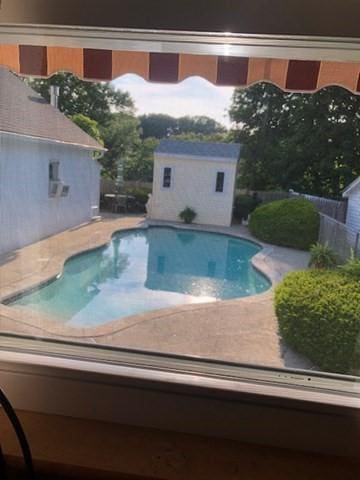 outdoor pool featuring an outbuilding