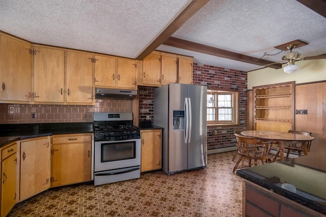 kitchen with brick wall, under cabinet range hood, beamed ceiling, appliances with stainless steel finishes, and a textured ceiling